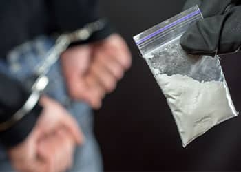 48901-police-arrest-drug-trafficker-with-handcuffs-c8528889.jpg