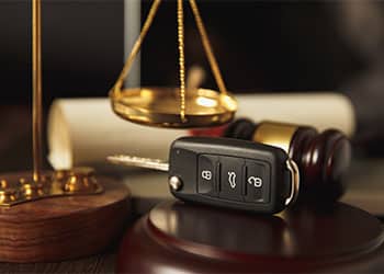81436-close-up-of-judge-gavel-and-car-keys-on-table-47a30877.jpg