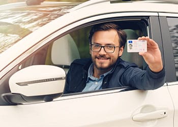 84001-man-showing-with-driver-license-7883386e.jpg